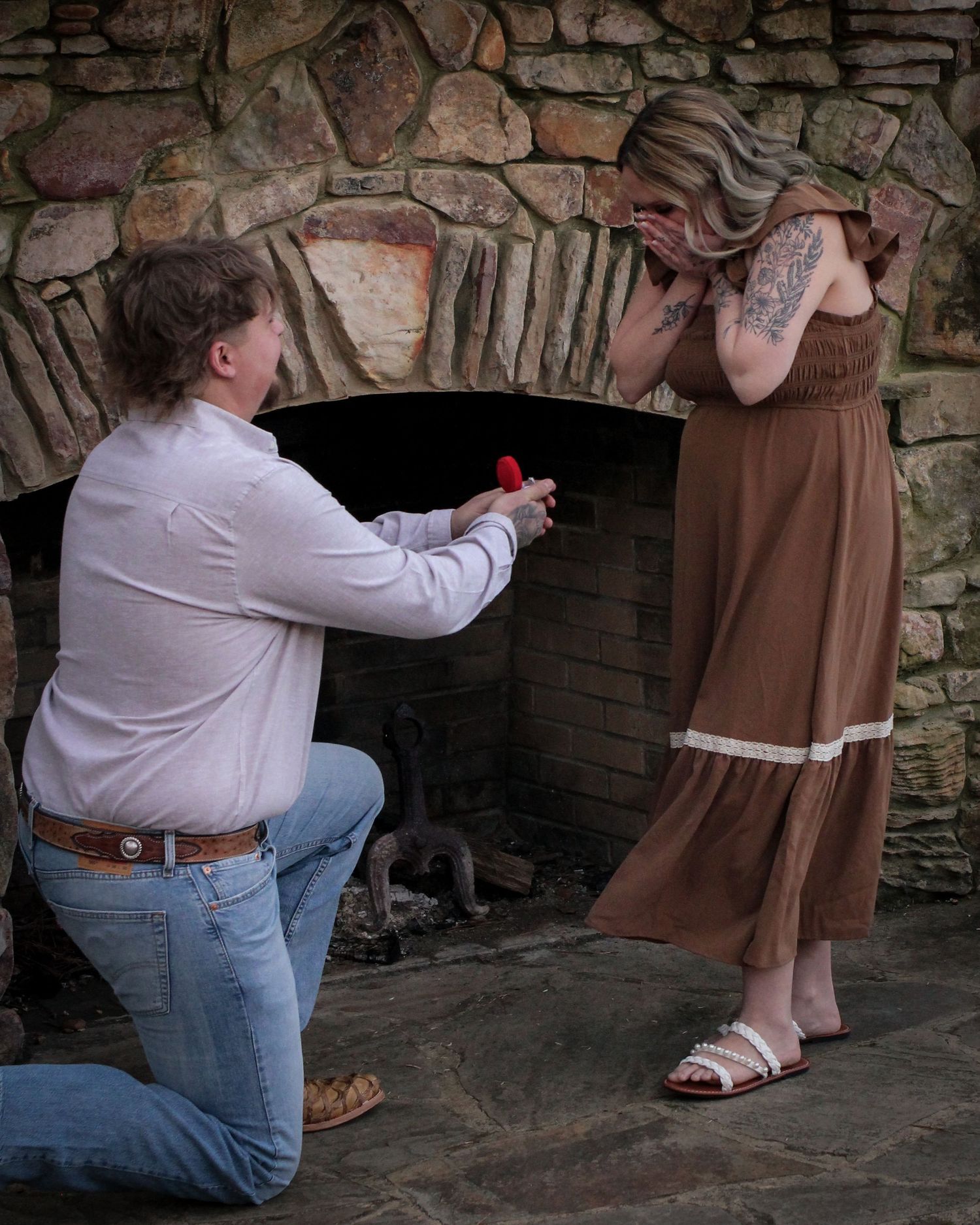 Couple portrait by stone fireplace