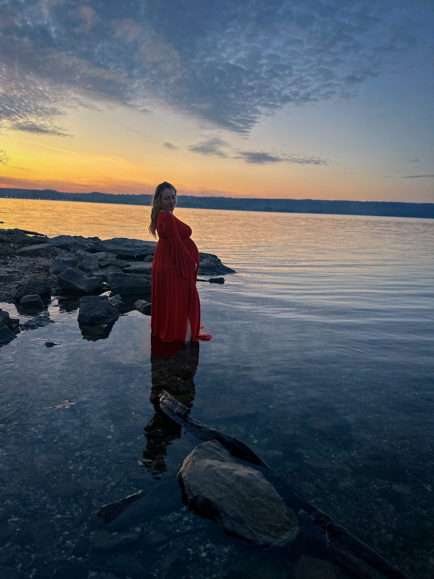 Maternity portrait by the water at sunset