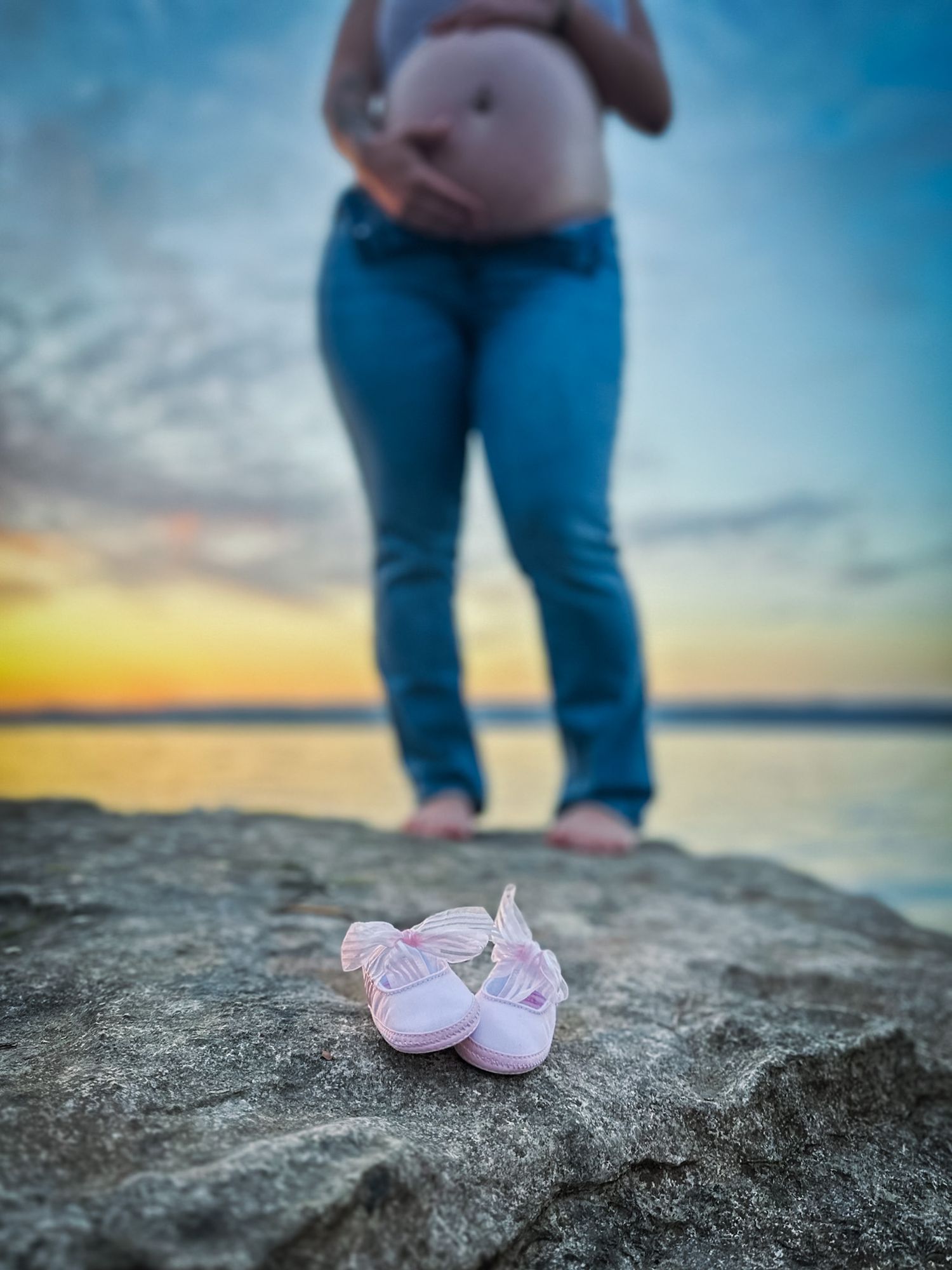 Close-up baby bump detail with belly ring